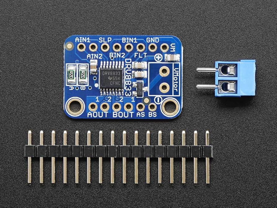 DRV8833 dual motor-driver breakout board with labeled motor outputs, input pins, sleep and fault pins, power connections, terminal block, and header pins. Photo: Adafruit.