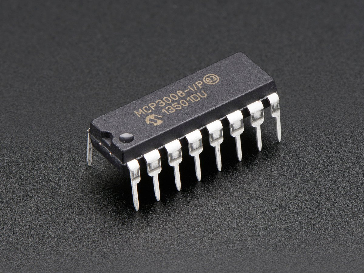 MCP3008 analog-to-digital converter in a 16-pin dual-inline package, showing its identifying label and orientation notch. Photo: Adafruit.